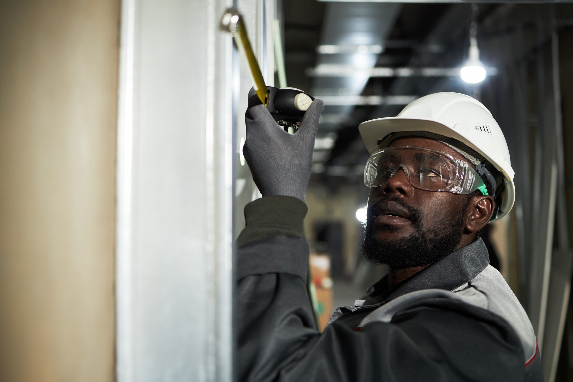 Male Worker Using Measure Tape