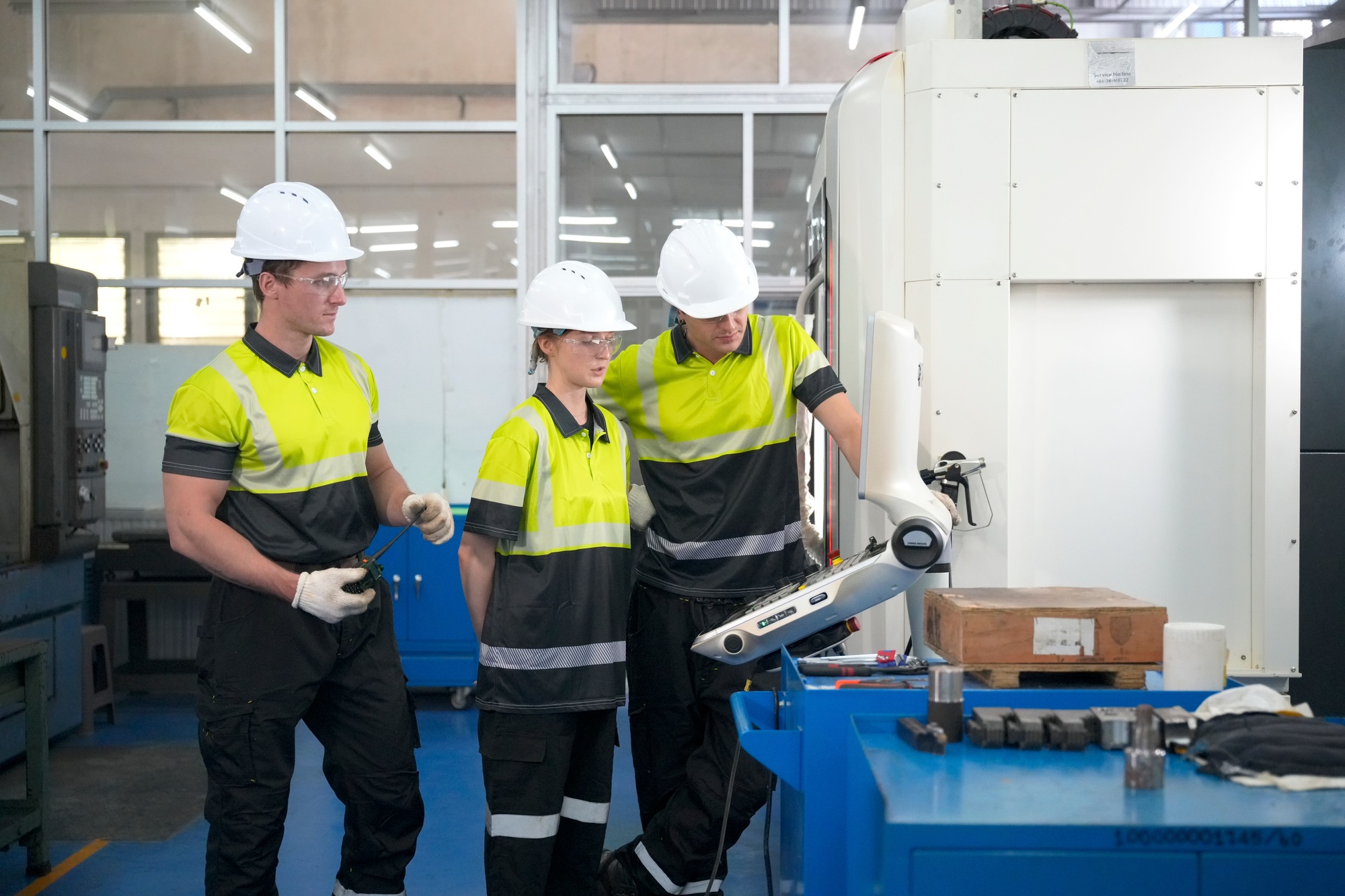 Workers collaborating in a modern manufacturing facility during industrial training session